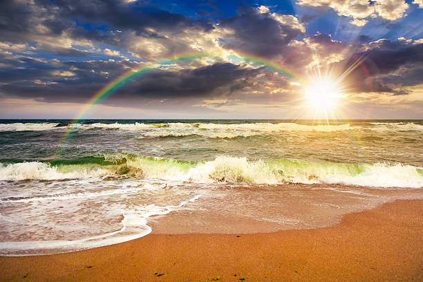 istock stormy beach scenery with waves splash on sand shore under scenic clouds on the sky at sunset 2233503844
