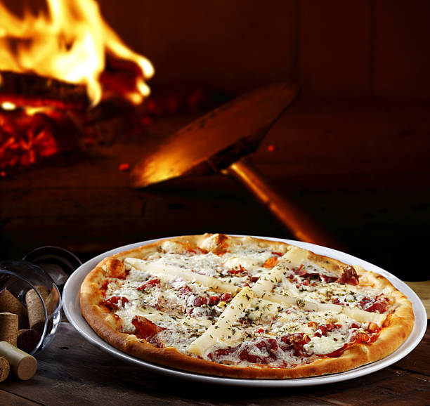 istock Pizzeria, Pizza baked in a wood-fired oven 2233503912