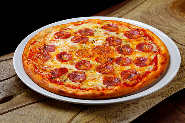istock Pizzeria, Pizza baked in a wood-fired oven 2233504010