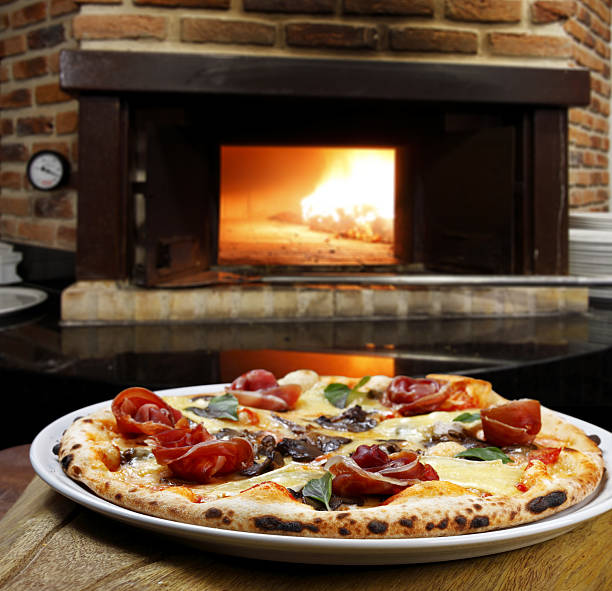 istock Pizzeria, Pizza baked in a wood-fired oven 2233504063