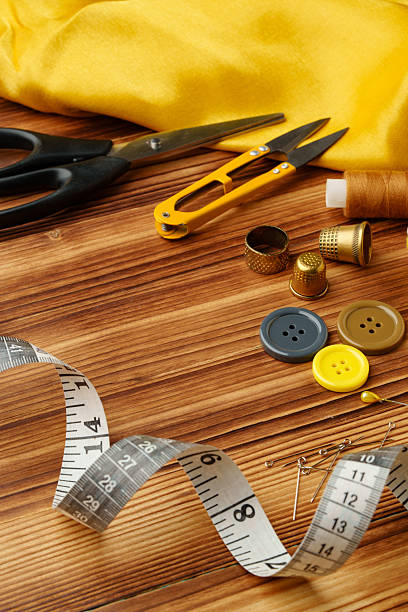 istock Crafting tools and materials arranged on a wooden table for sewing projects 2233506317