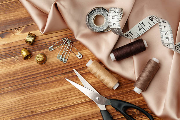 Sewing tools and materials arranged on soft fabric showcasing essential crafting supplies for creative projects