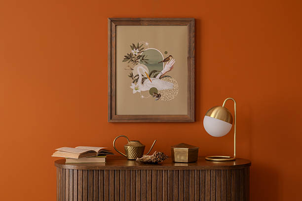 istock Modern interior with warm orange tones, sculptural accessories, and mock up  wall art. A curated setup blending nostalgia and contemporary aesthetics. 2233506449