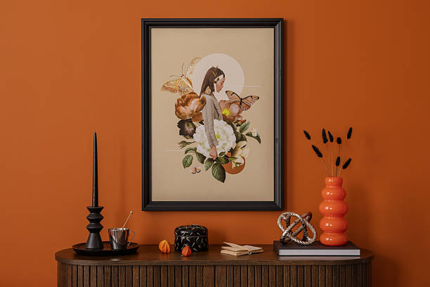 Modern eclectic interior with dark wood textures, mock up wall art, playful accessories in vivid orange tones.
