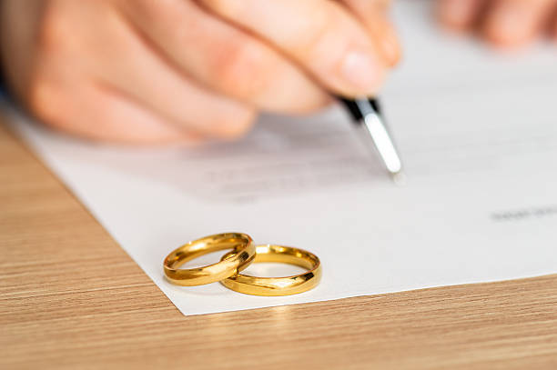 istock Divorce, rings and signature on paperwork 2233506917