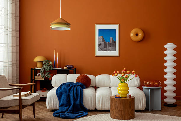 istock Modern interior with modular sofa, decorations, tulips, mock up abstract paintings on the orange wall. Template. 2233507575