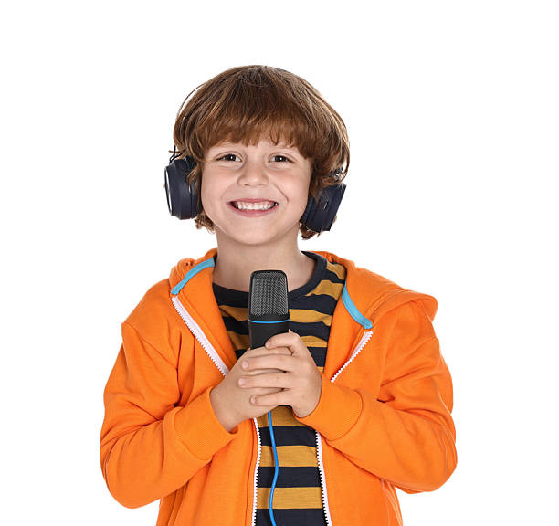 istock Little boy with microphone and headphones on white background 2233511874