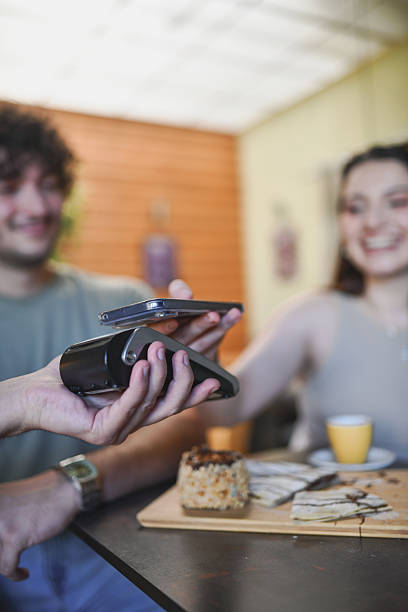 istock Female Paying For Coffee And Dessert With Mobile Phone 2233511919