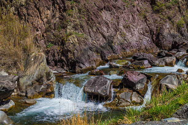 istock Flowing water over rocks in serene mountainous stream 2233513904