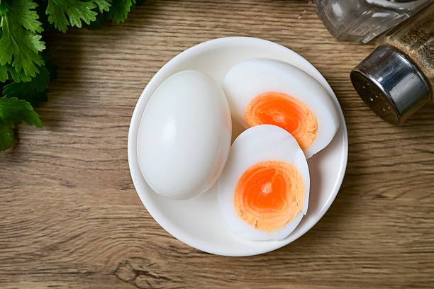 istock Medium-boiled egg,Boiled egg in white plate on wooden background 2233516702