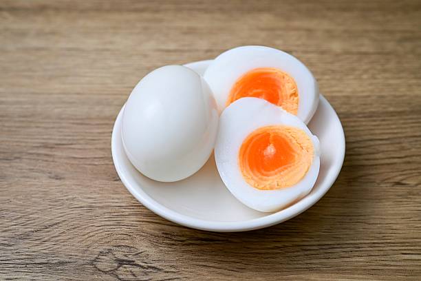 istock Medium-boiled egg,Boiled egg in white plate on wooden background 2233516712