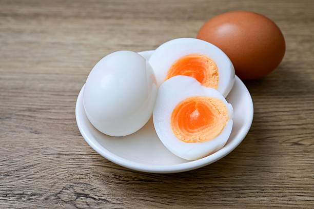 istock Medium-boiled egg,Boiled egg in white plate on wooden background 2233516717