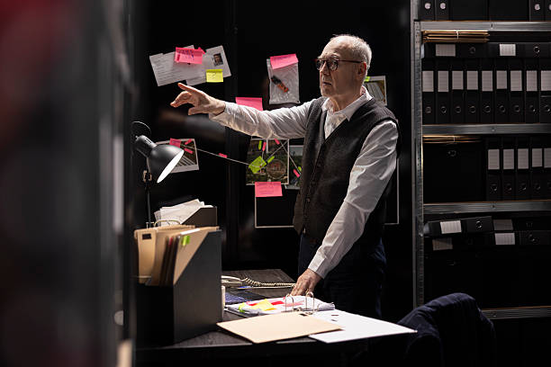 istock Senior man detective studying evidence and making connections 2233518148