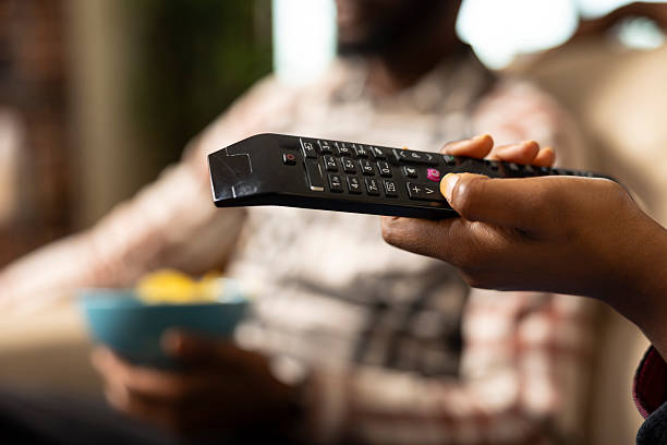 istock Black woman Switching Channels with Remote 2233518649