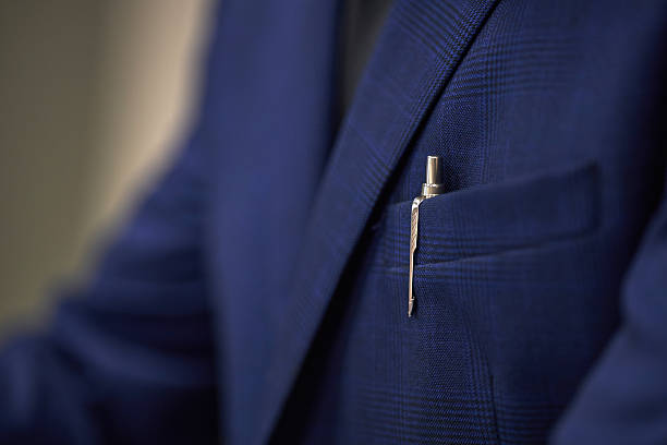 istock Anonymous Businessman Wearing Suit Jacket Holding Pen in Pocket 2233519304
