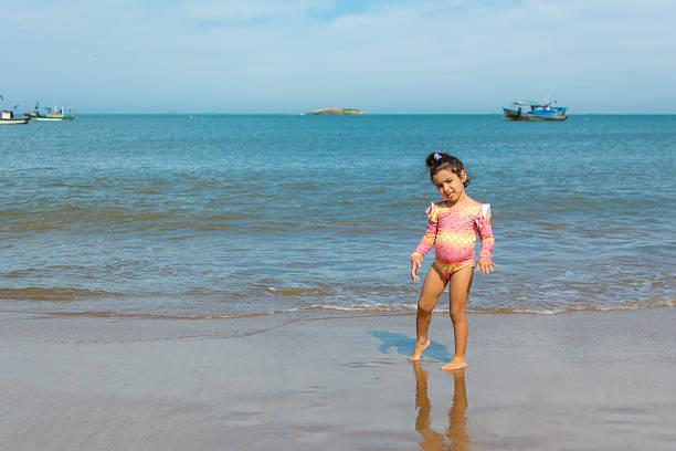 A little Indian girl enjoying her vacation at beach, Mumbai, India