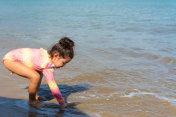 Beautiful girl having fun on a river during hot summer day.