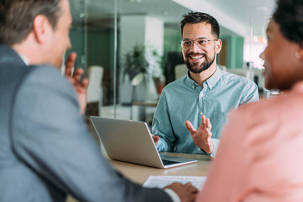 istock Group of business persons talking in the office. 2233519874
