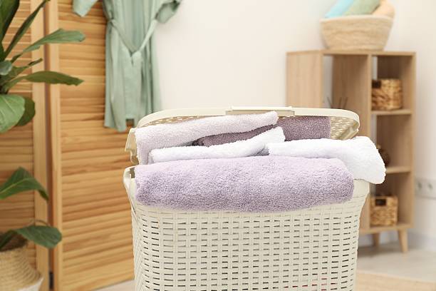 istock Wicker basket full of laundry in bathroom, closeup 2233520195