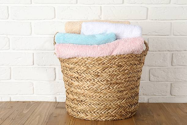 istock Wicker basket full of laundry on wooden table 2233520226