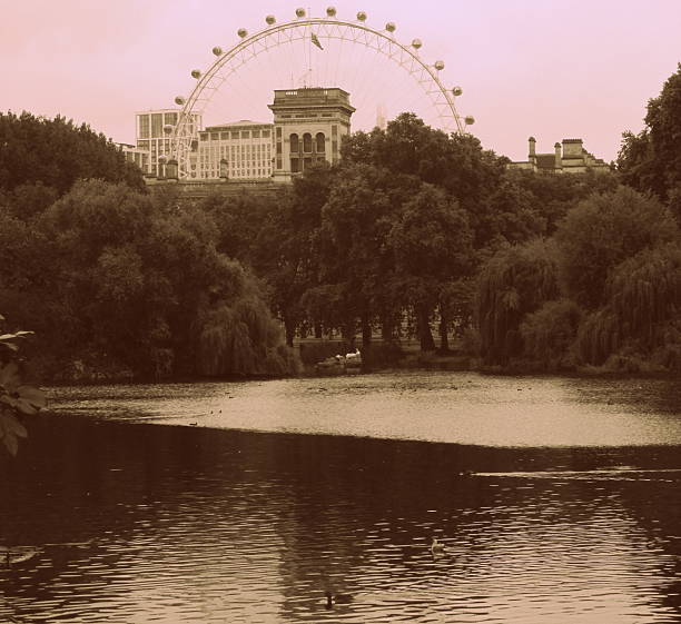 London, UK - October 09, 2023 : A low angle view of the London Eye, a giant Ferris wheel against a blue sky.