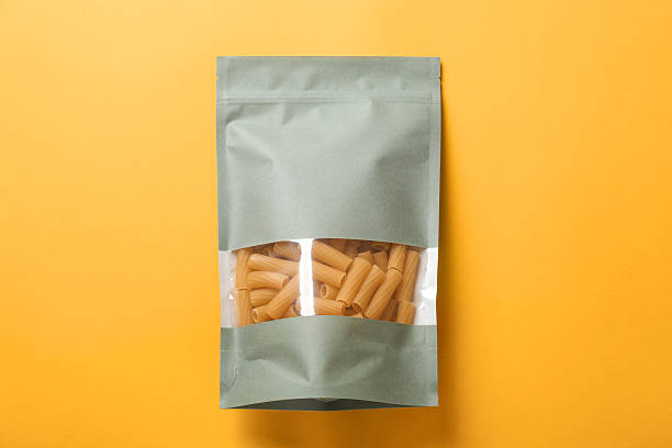 istock Paper pouch bag with pasta on yellow background, top view 2233520641