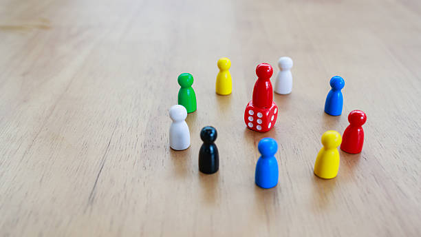 istock Leadership and teamwork concept illustrated by a central pawn standing on a red dice, surrounded by colorful pawns, symbolizing risk, decision making, and collective strategy 2233523467