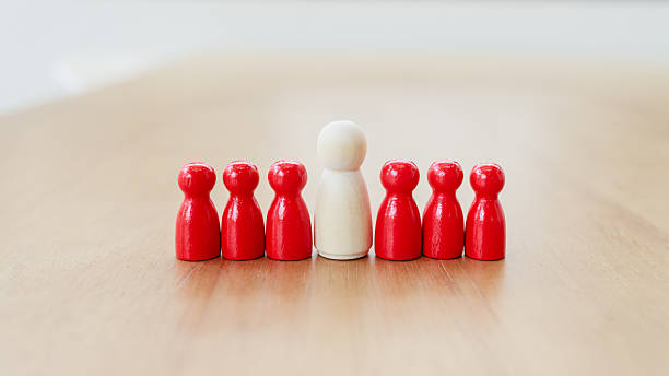 istock Leadership and teamwork concept where a central white leader figure guides and unites red team members, symbolizing support, trust, and collaboration for achieving shared goals 2233523469