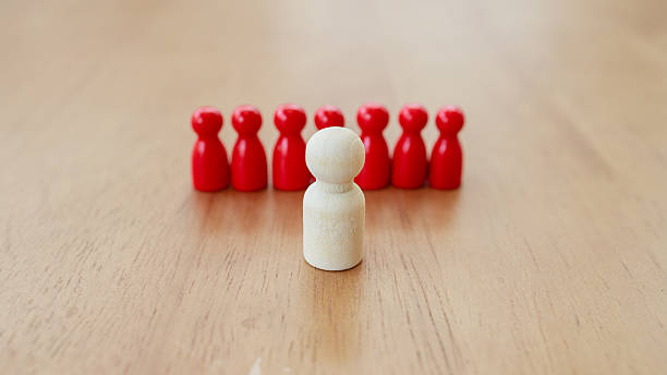 istock Leadership and teamwork concept where a central white leader figure guides and unites red team members, symbolizing support, trust, and collaboration for achieving shared goals 2233523489