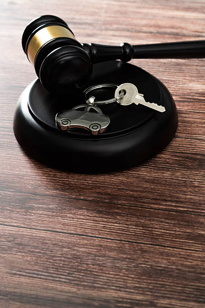 istock Gavel and car key on the table 2233524681