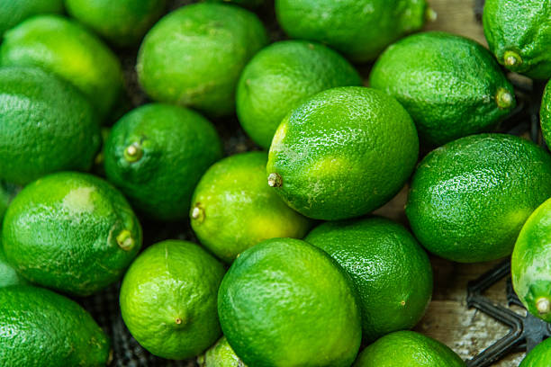 Top view of fresh green limes background full frame