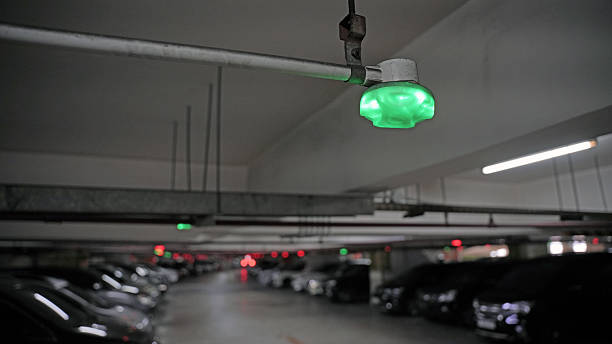 istock Car Parking lot with smart sensors on ceiling, Indicator Light show Parking space unoccupied is green 2233525175