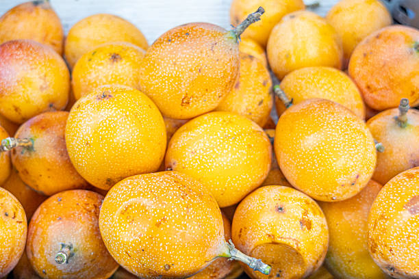 Granadilla fruits from Ecuador, an exotic Andean delicacy with sweet and refreshing pulp, symbol of tropical biodiversity, healthy food, and South American agricultural richness.