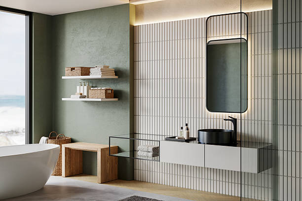 istock Modern minimalist bathroom interior with freestanding bathtub, vanity unit, shelves, mirror, and natural light. Japandi-inspired design with green wall, wood bench, woven baskets, and cozy accessories. 3D render. 2233526265