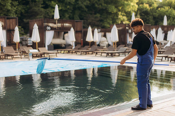 istock Pool cleaner using landing net cleaning swimming pool water surface 2233527237