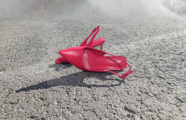 istock women's pink shoes with thin high heels lie on the sidewalk, copy space 2233527704