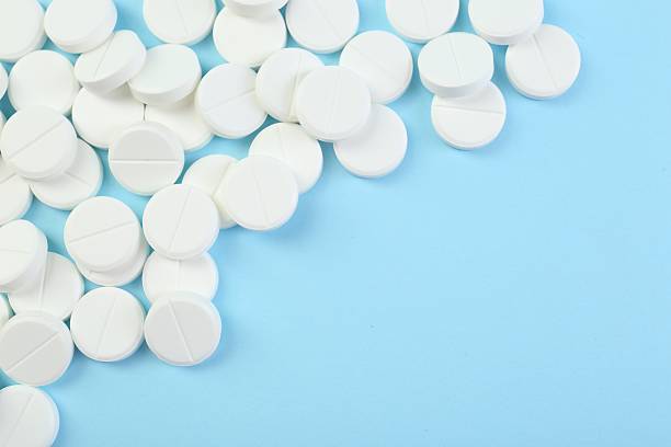 istock Many antibiotic pills on light blue background, top view. Space for text 2233528155