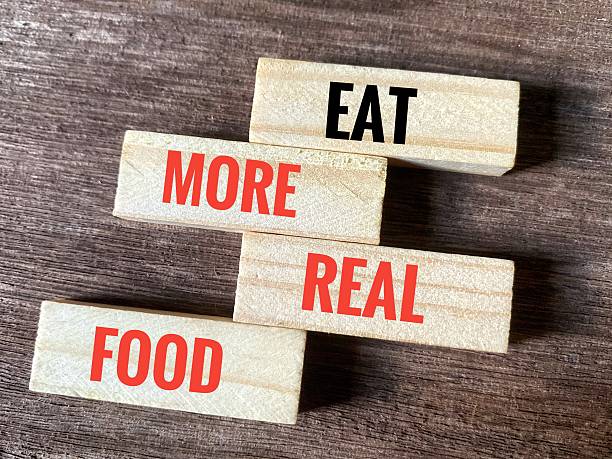 istock Eat More Real Food on wooden blocks. 2233530144