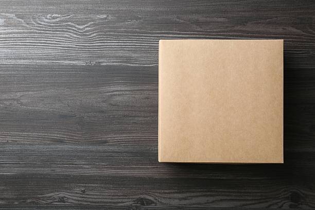 istock One blank cardboard box on wooden background, top view. Mockup for design 2233530165