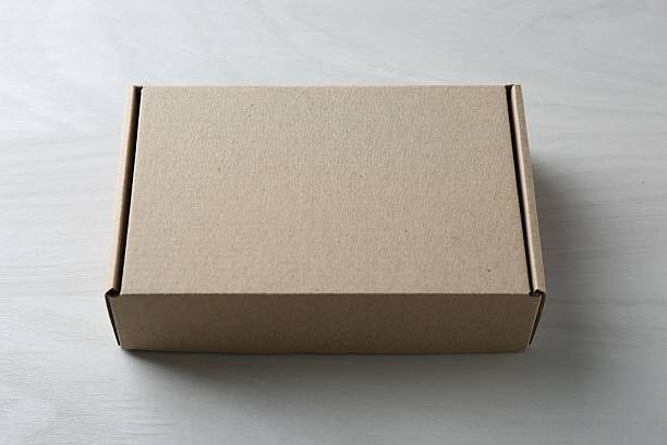 istock One blank cardboard box on white wooden background. Mockup for design 2233530213