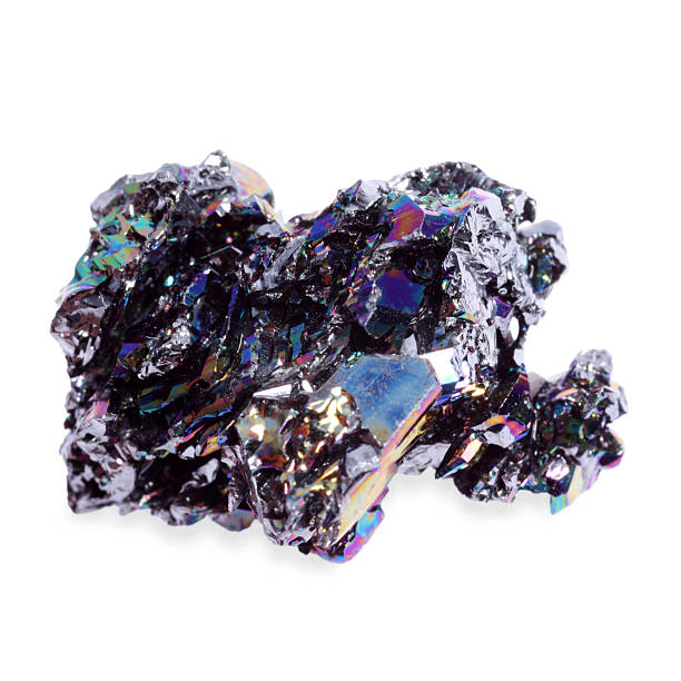 Colored gems and gemstones spilling out of black bag onto white.