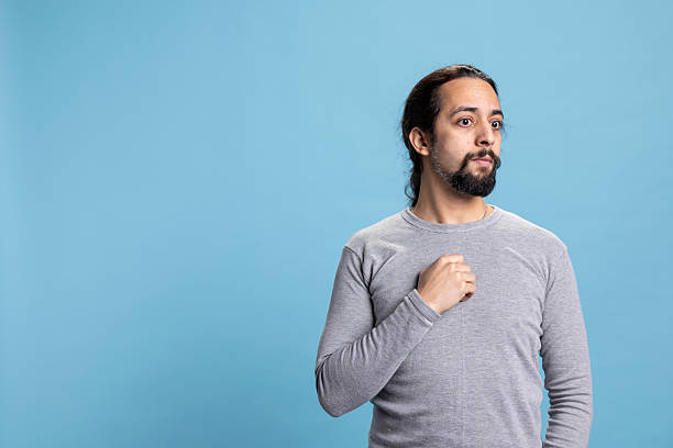 istock Confused distraught young man feeling troubled and anxious in studio 2233532941