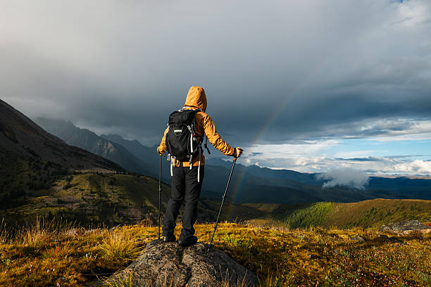 istock Woman backpacker hiking on high altitude mountains top 2233533078