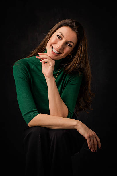 istock Brunette haired woman against isolated dark background 2233535522
