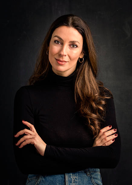 istock Brunette haired woman against isolated dark background 2233535533