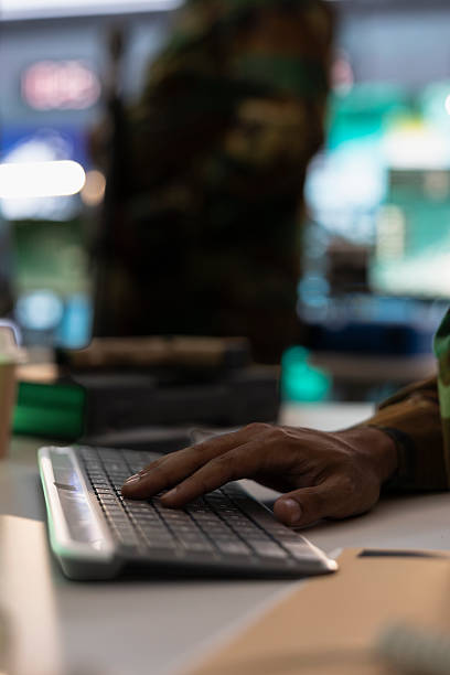 istock Army officer typing on keyboard, using surveillance equipment 2233537594