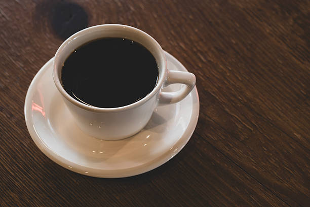 istock Hot coffee in white mug with dark backdrop. 2233538364