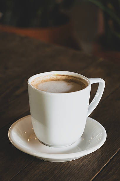 istock Hot latte coffee in white cup. Dark background. 2233538417