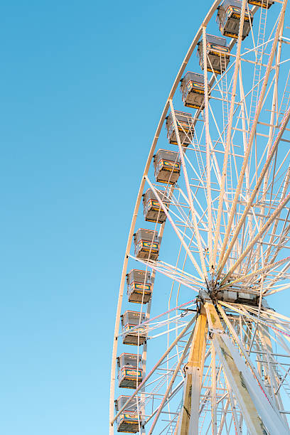 istock Giant Ferris wheel with empty cabins in sunlight 2233538590