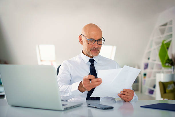 istock Caucasian man with laptop sitting at office desk and working 2233539310